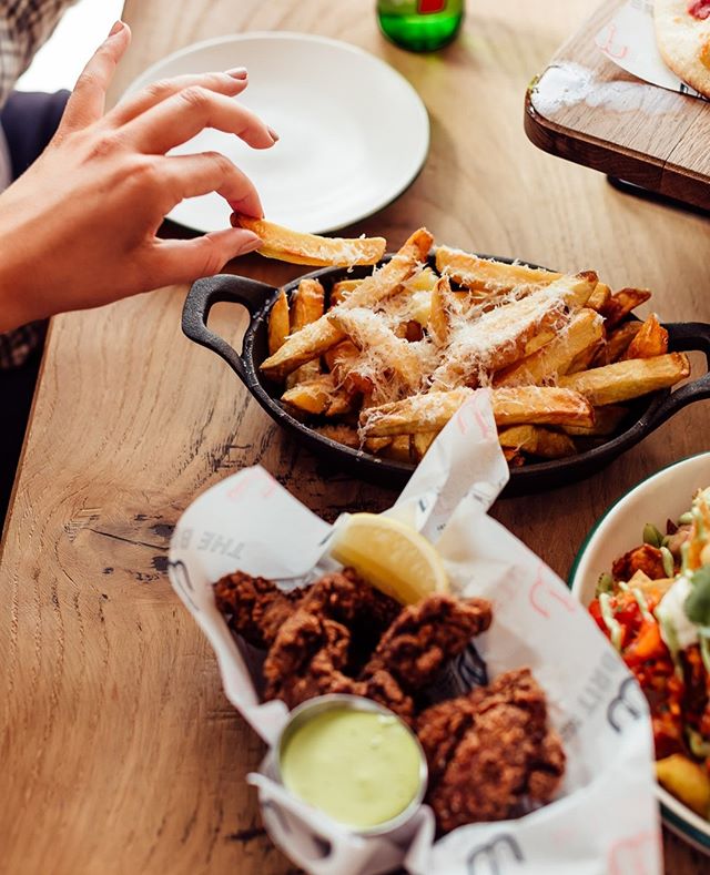 The universal hand signal for "let me just test how hot these cheesy truffle fries are"